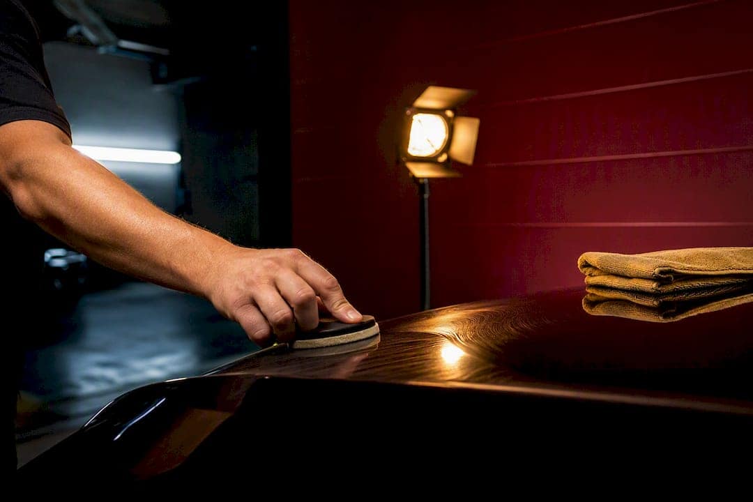 Technician polishing an anonymous vehicle surface