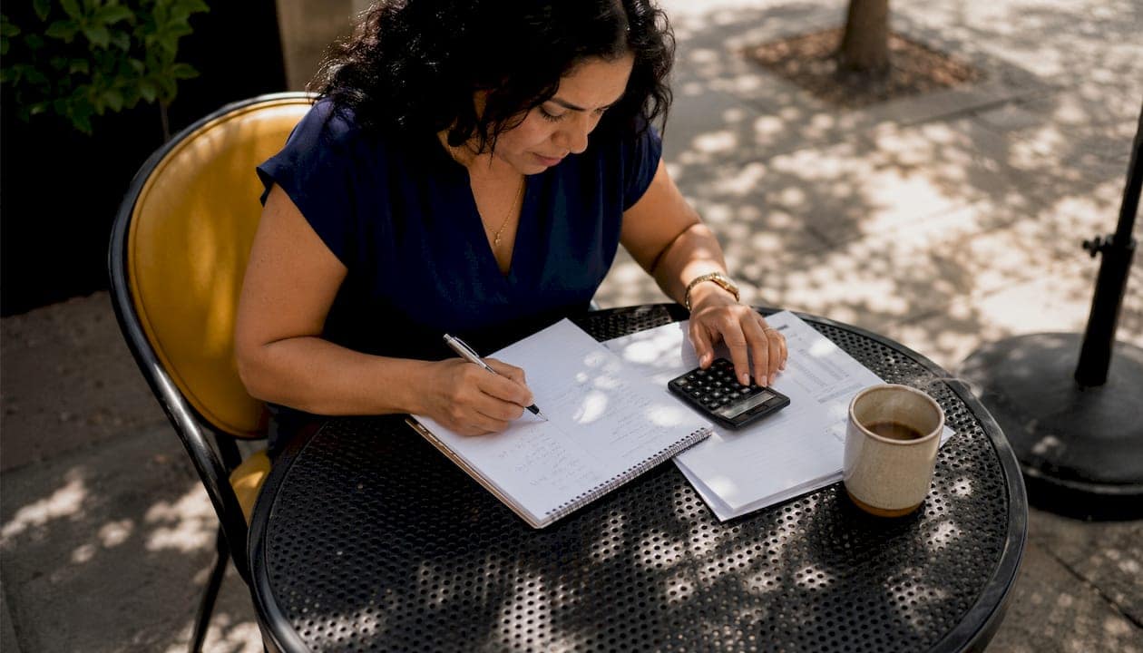 Small business owner calculating ad budget