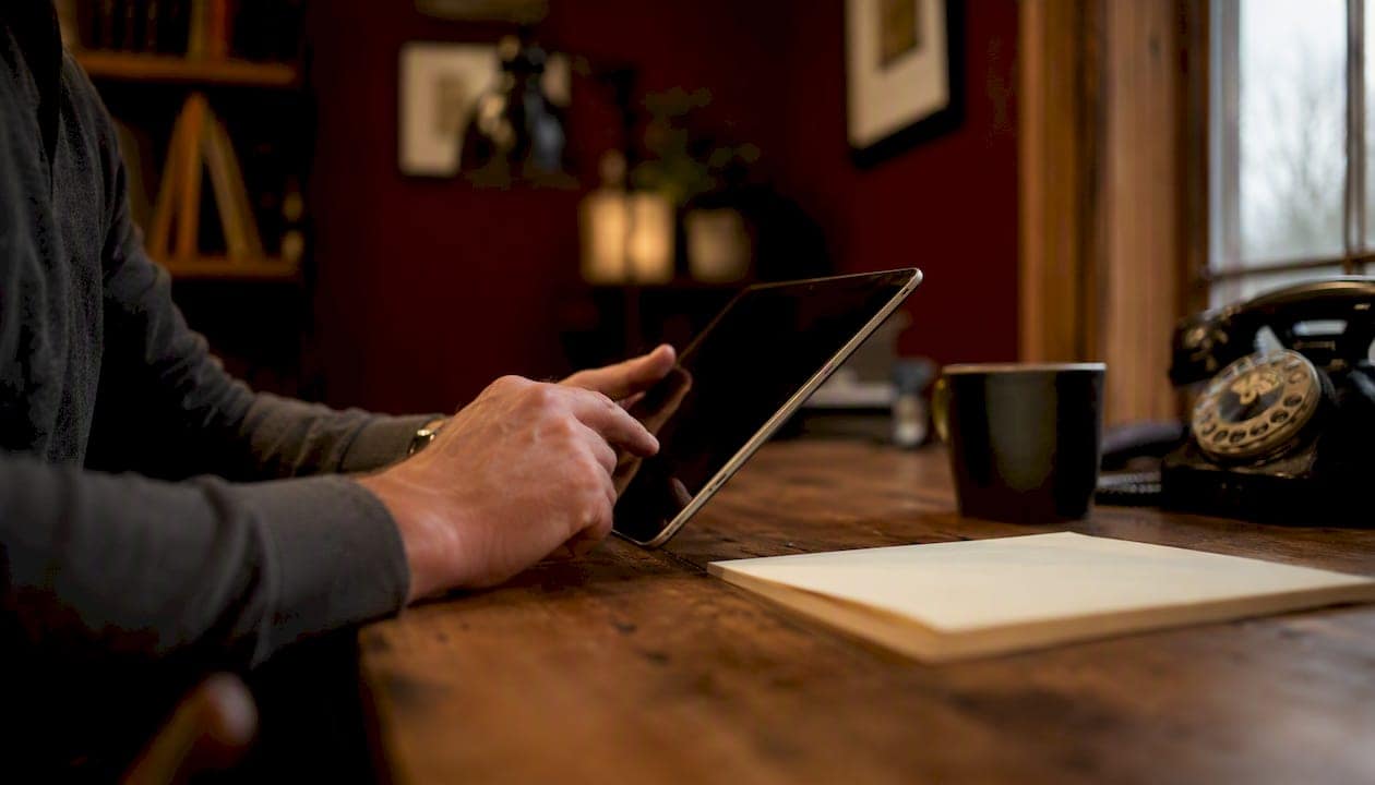 Contractor's hands entering client data on tablet