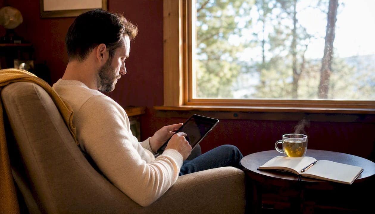 Overhead of man using tablet with review dashboard