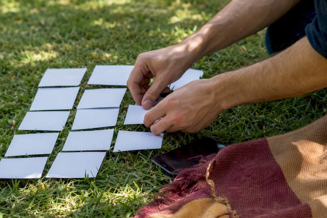 Hands arranging SEO topic cards on table